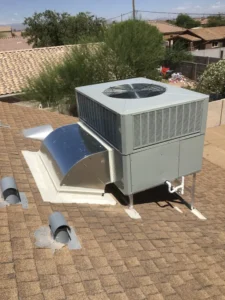 Close view of a rooftop AC unit's fan housing and refrigerant lines during service